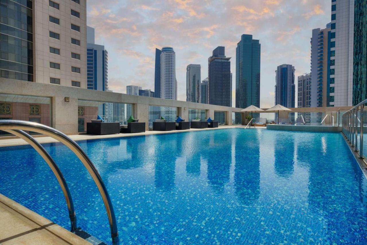 Wyndham Grand Doha West Bay Beach Экстерьер фото The swimming pool at the hotel